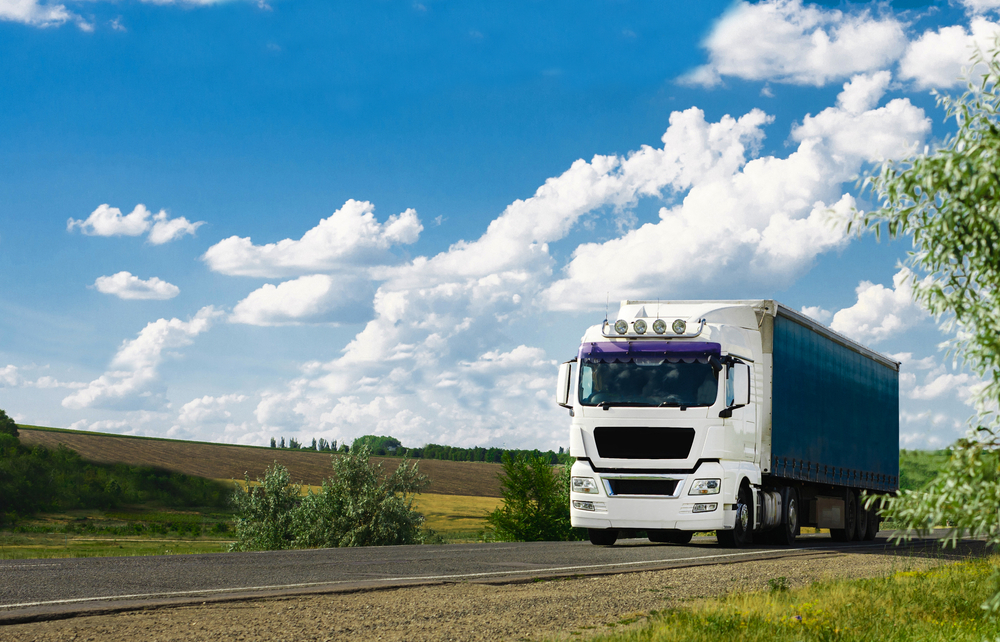 European,Truck,Vehicle,With,Container,On,Highway,And,Blue,Sky